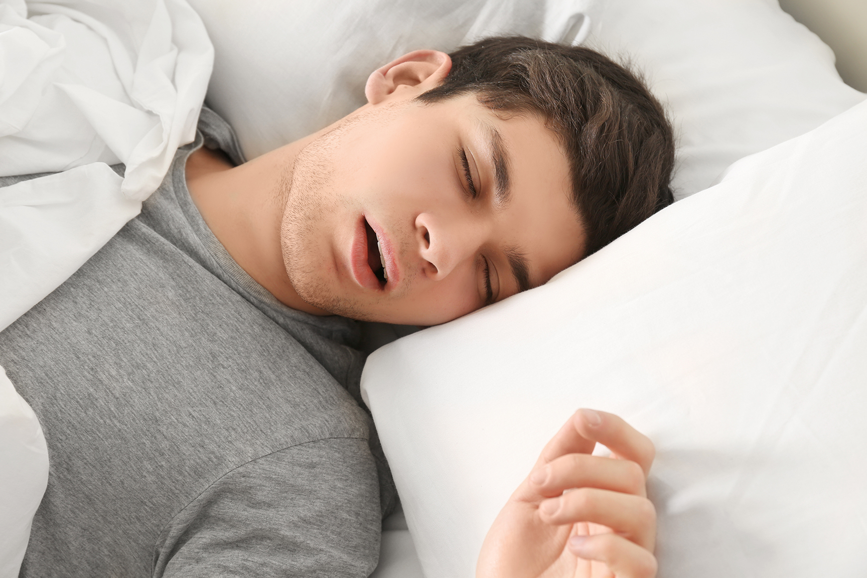 man with sleep apnea sleeping in bed
