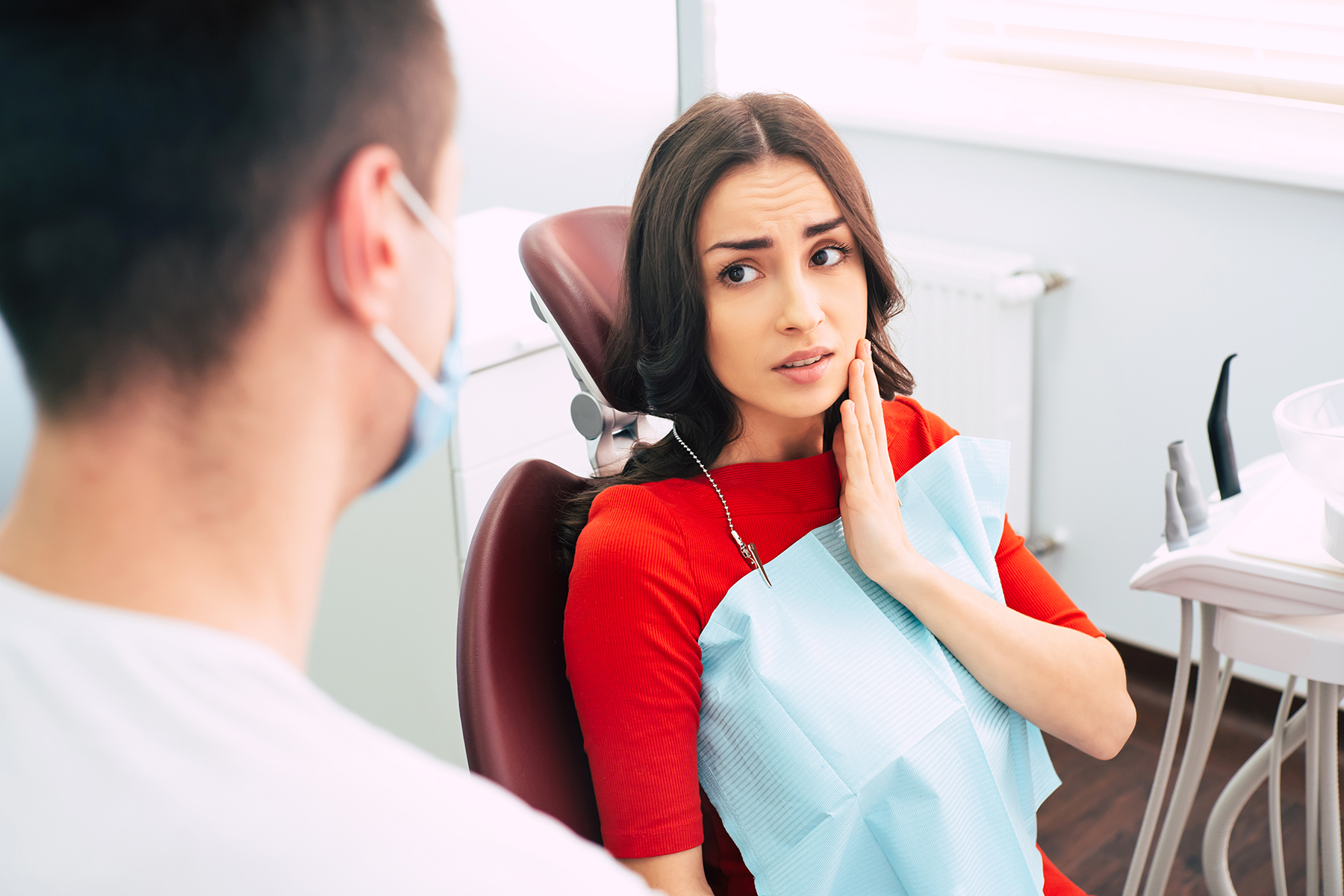 Woman who needs a tooth extraction in Canton, OH